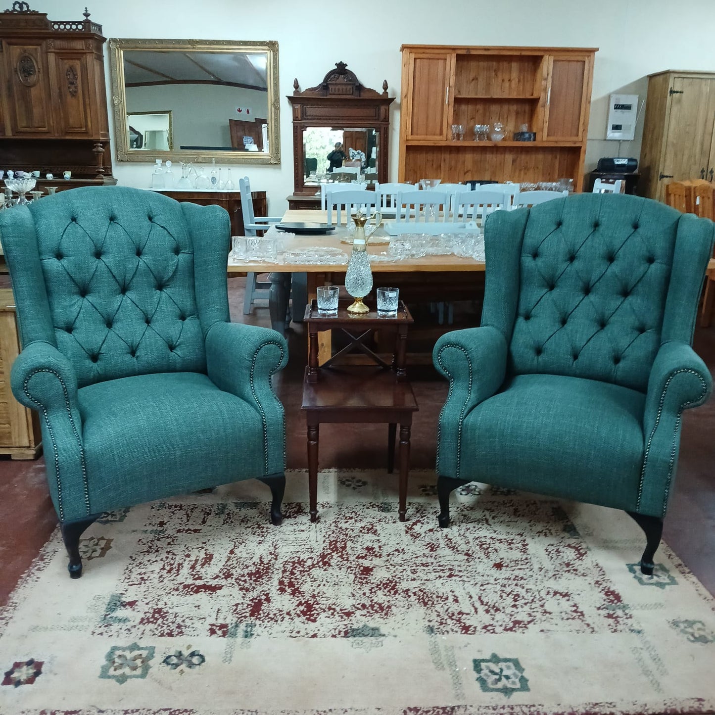 Deep buttoned green wingback chairs