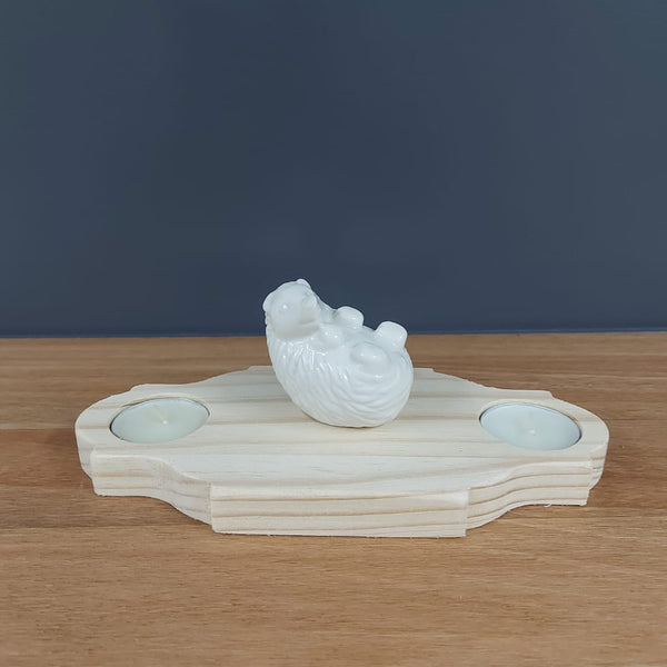 2 candles and a hedgehog deco